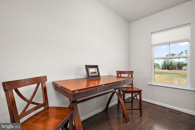 office space featuring dark wood-style flooring, visible vents, and baseboards