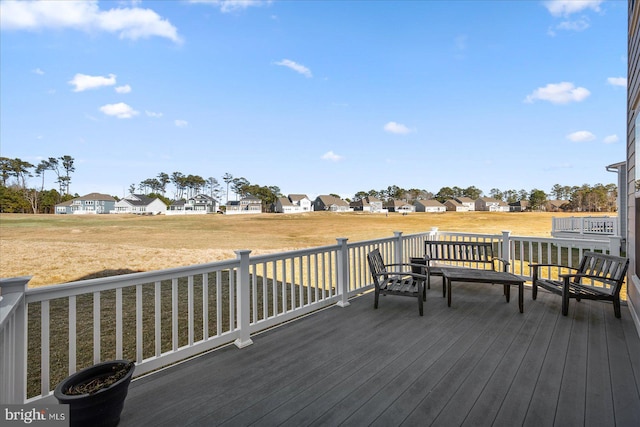 wooden deck featuring a residential view and a lawn