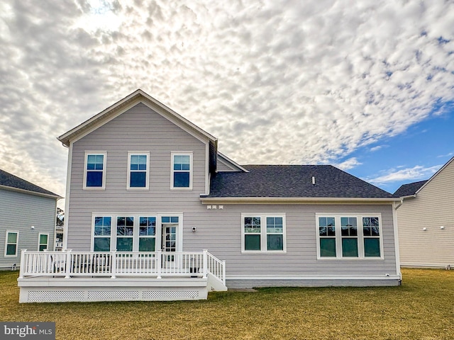 back of house with a lawn and a wooden deck