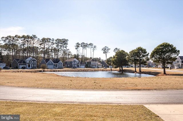 view of yard with a water view and a residential view