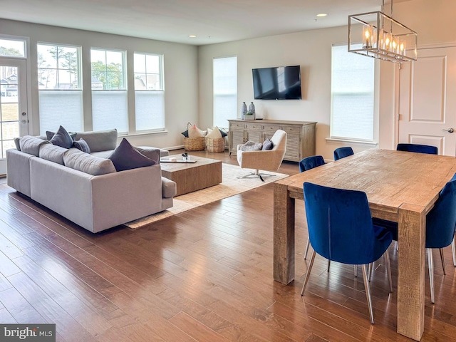 living room featuring an inviting chandelier, hardwood / wood-style floors, and recessed lighting