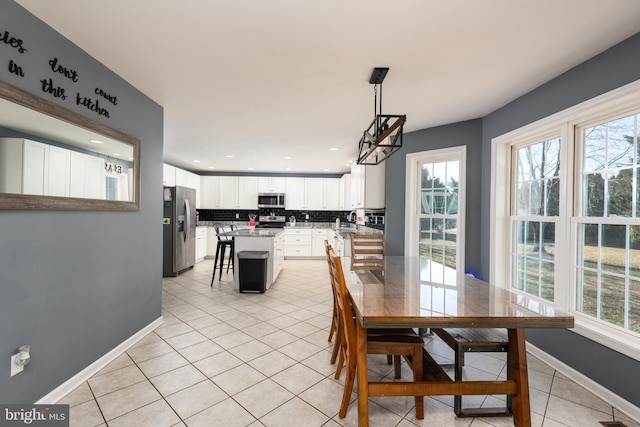 dining room featuring light tile patterned floors, recessed lighting, and baseboards