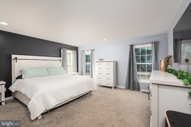 carpeted bedroom featuring recessed lighting and baseboards