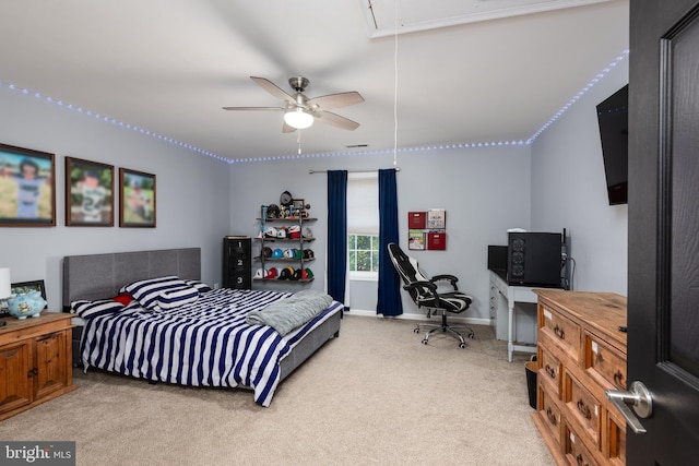 bedroom featuring baseboards, a ceiling fan, attic access, and light colored carpet