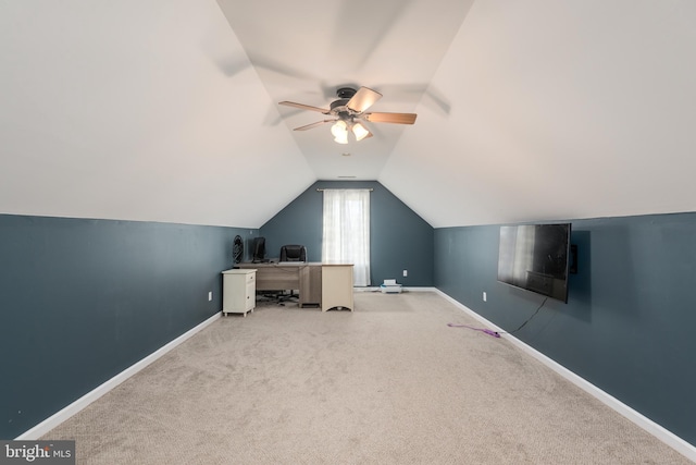 interior space featuring baseboards, vaulted ceiling, and carpet flooring