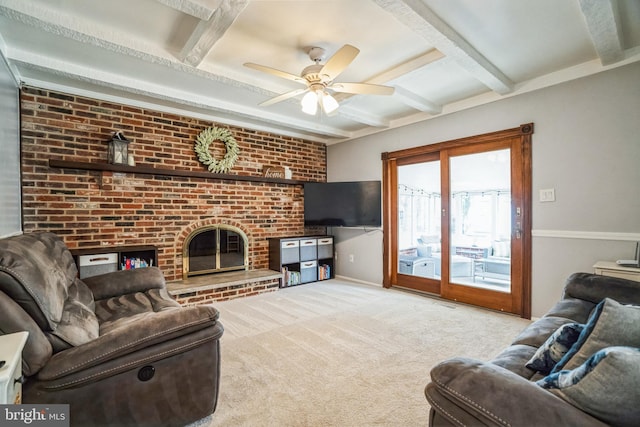 living room with carpet floors, a fireplace, a ceiling fan, and beamed ceiling