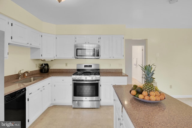 kitchen with appliances with stainless steel finishes, white cabinets, and a sink