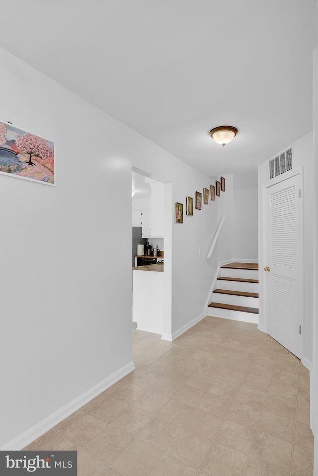 interior space with stairway, visible vents, and baseboards