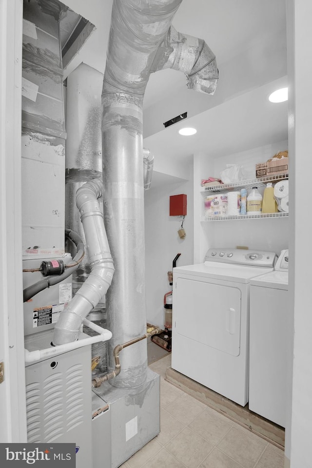 laundry room featuring laundry area, independent washer and dryer, and light tile patterned flooring