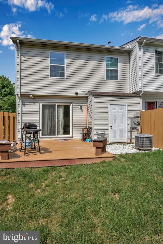 back of house with a yard, fence, and a wooden deck