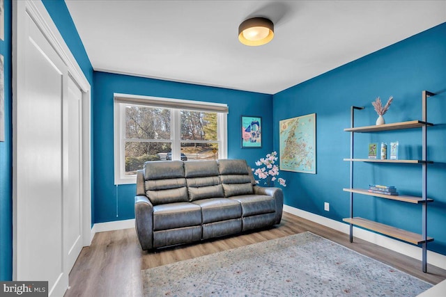 living room featuring wood finished floors and baseboards