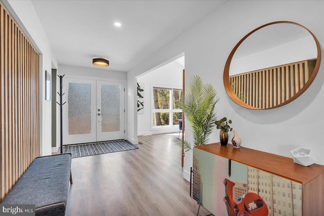 entryway with light wood-style floors, recessed lighting, french doors, and baseboards