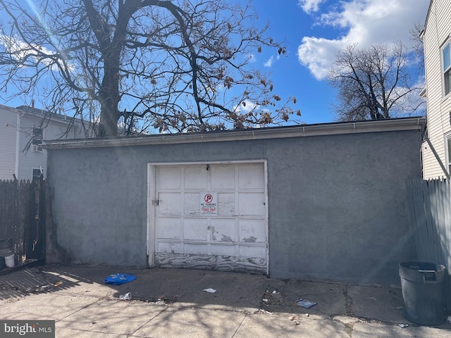 detached garage with driveway and fence