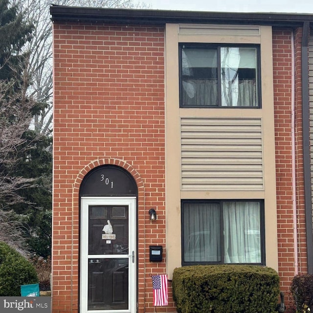 property entrance with brick siding