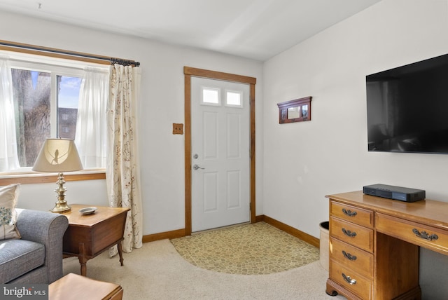 entrance foyer with light carpet and baseboards