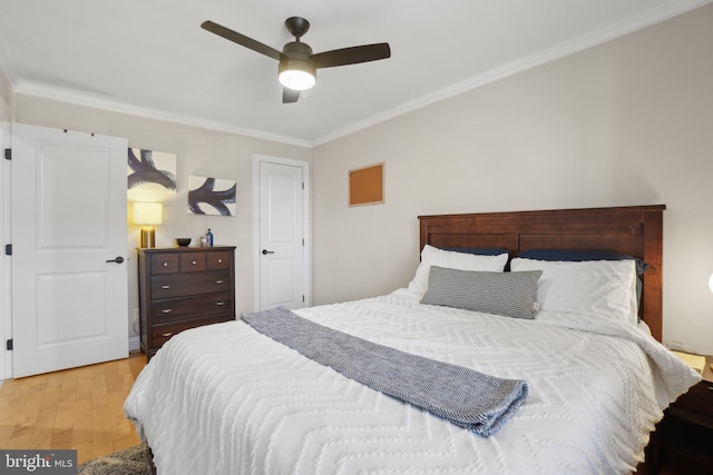 bedroom featuring ornamental molding, ceiling fan, and light wood finished floors