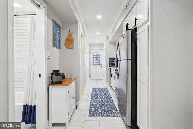 hallway with light tile patterned floors, visible vents, crown molding, and recessed lighting