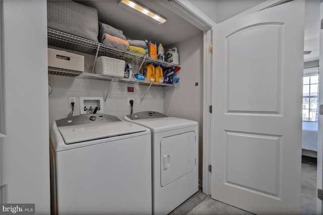 clothes washing area with washer and dryer and laundry area