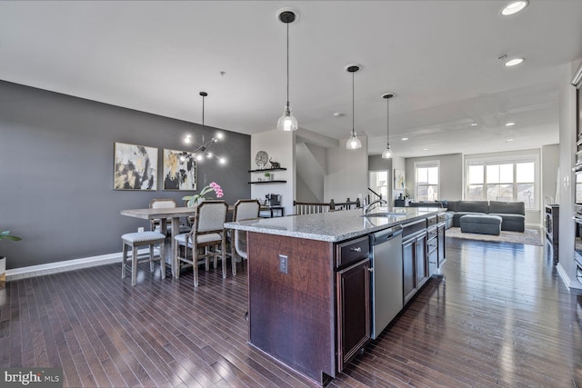 kitchen with baseboards, dark wood-style flooring, open floor plan, and dishwasher