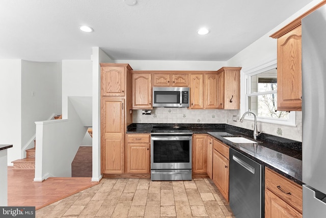 kitchen with stainless steel appliances, recessed lighting, a sink, and tasteful backsplash