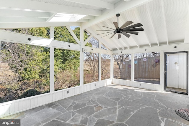 unfurnished sunroom with vaulted ceiling with skylight and ceiling fan