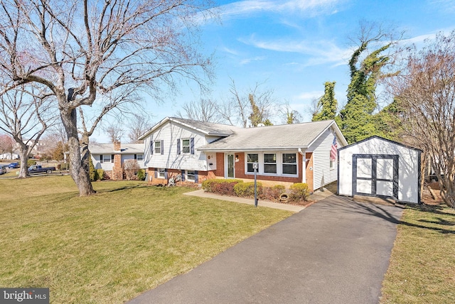 tri-level home featuring driveway, a storage shed, an outdoor structure, a front lawn, and brick siding