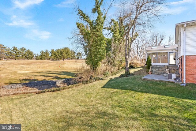 view of yard featuring a sunroom