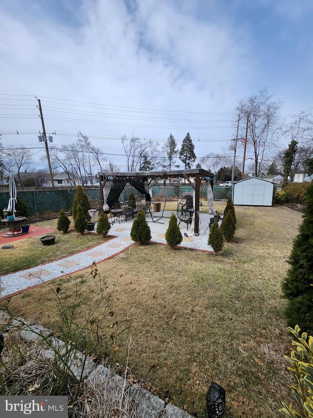 view of yard featuring fence, an outdoor structure, a patio area, a shed, and a pergola