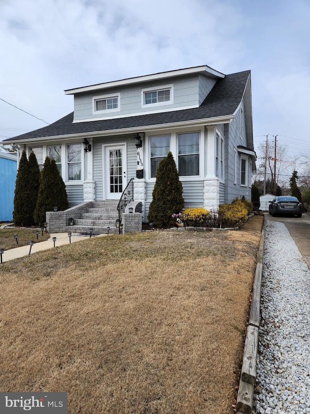 bungalow-style home with a front yard