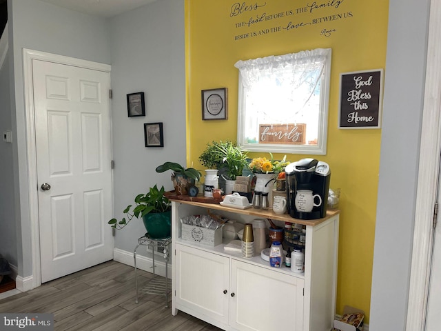 bar featuring baseboards and wood finished floors