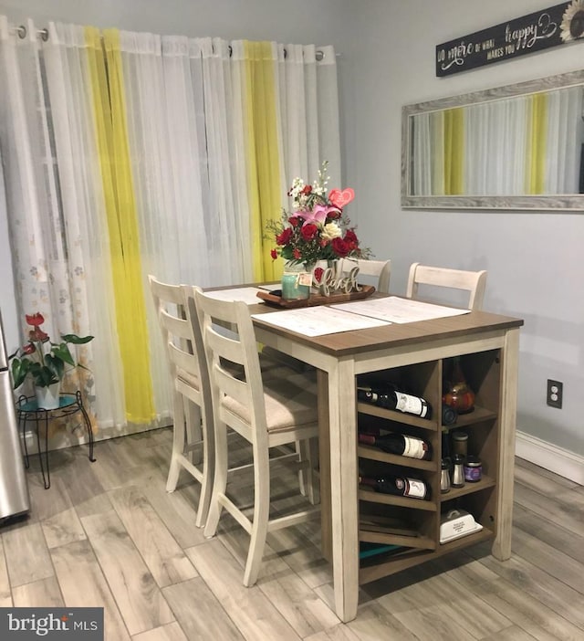 dining area with wood finished floors