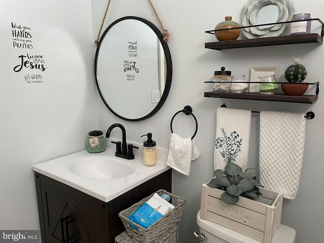 bathroom with toilet and vanity