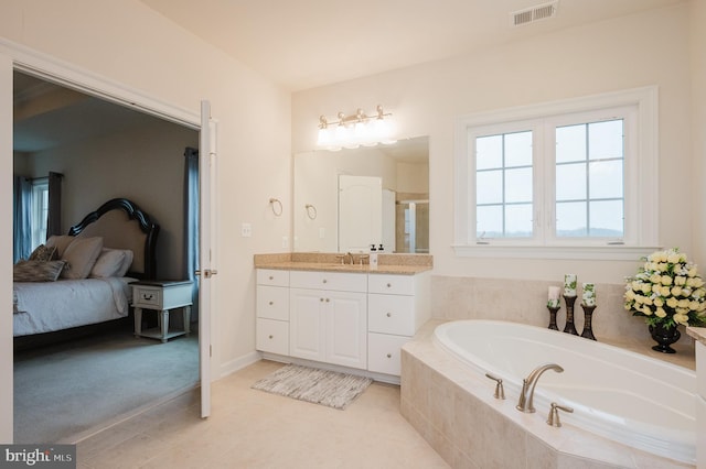 ensuite bathroom featuring ensuite bathroom, vanity, visible vents, a bath, and a stall shower