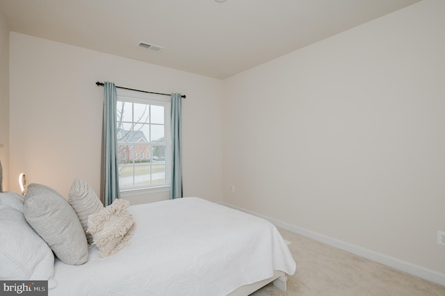 carpeted bedroom featuring visible vents and baseboards