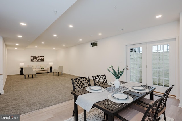 dining space with baseboards, light wood-type flooring, and recessed lighting