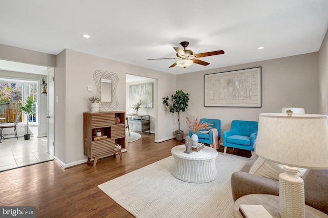 living area with recessed lighting, baseboards, ceiling fan, and wood finished floors