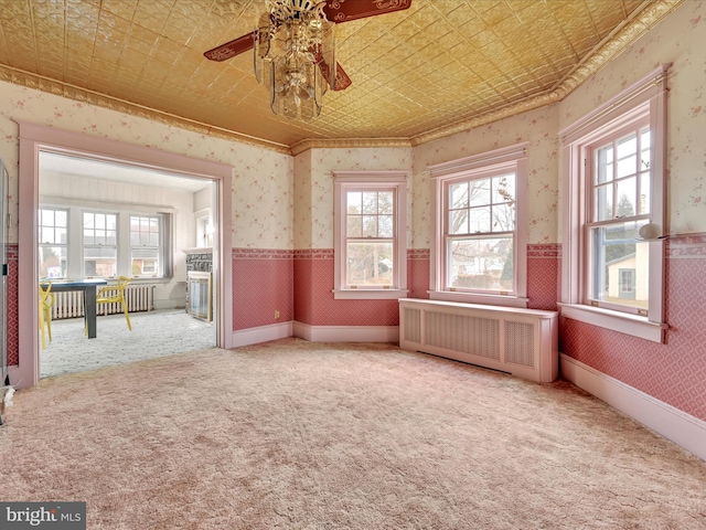 interior space featuring radiator heating unit, wainscoting, an ornate ceiling, and wallpapered walls