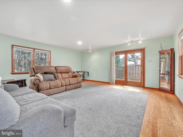 living room featuring light wood-type flooring and baseboards