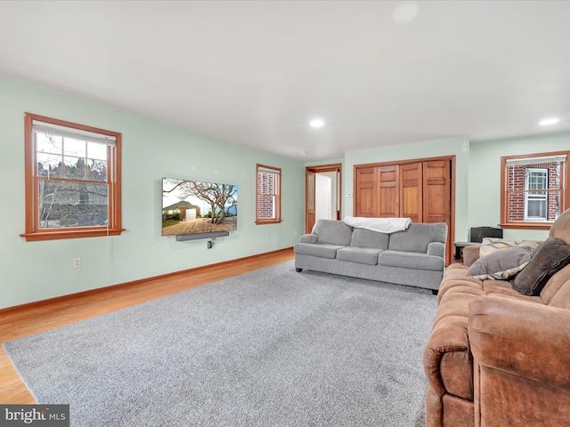 living room with recessed lighting, baseboards, and wood finished floors