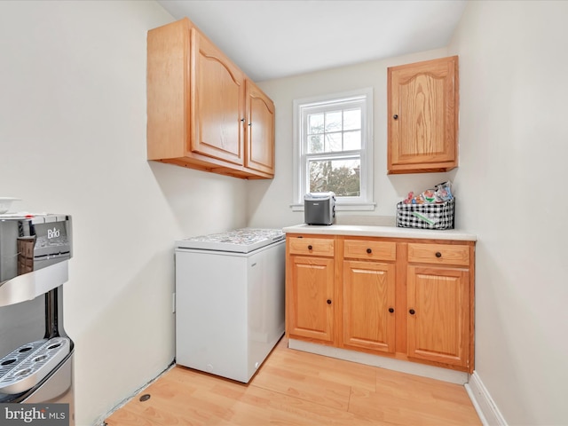 washroom featuring light wood-type flooring and baseboards