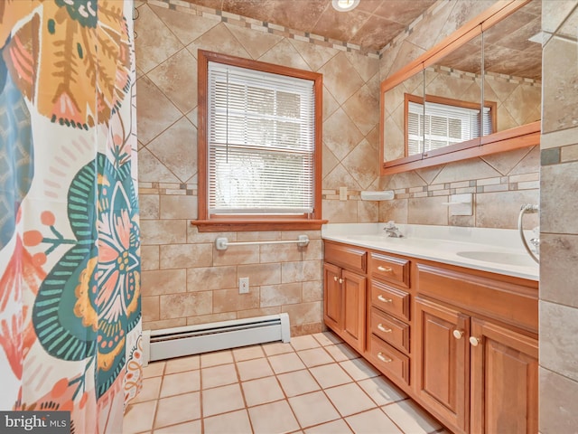 full bath with a baseboard heating unit, a sink, tile walls, and double vanity