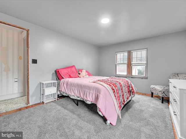 bedroom featuring carpet floors and baseboards