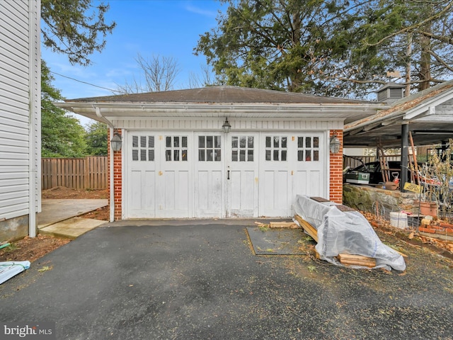 detached garage featuring fence