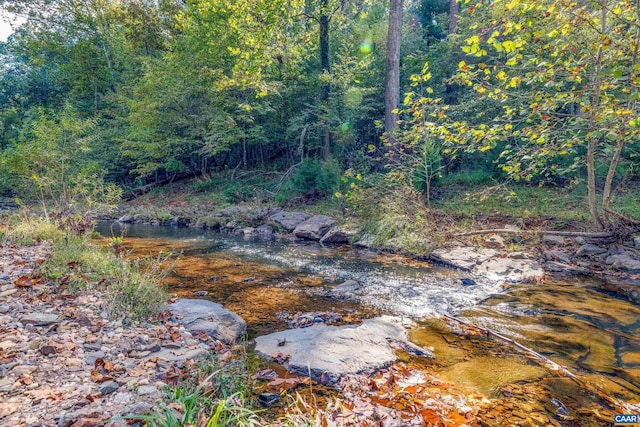 view of landscape featuring a forest view