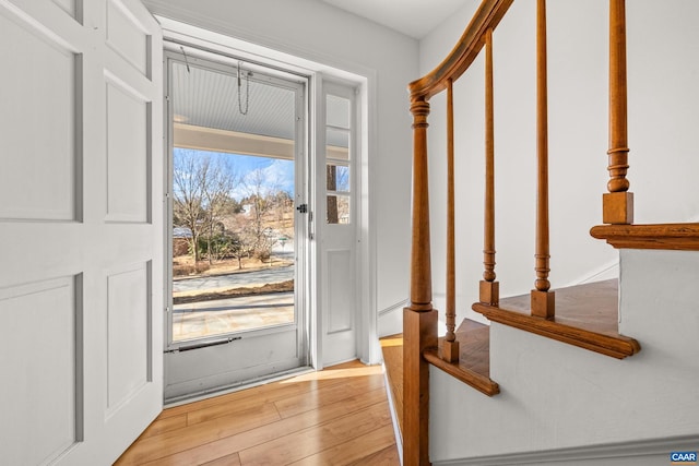 doorway to outside with light wood-style floors