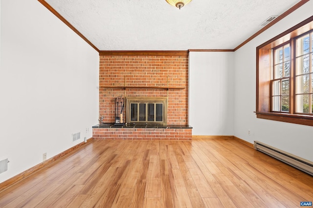 unfurnished living room featuring light wood-type flooring, visible vents, a baseboard heating unit, and crown molding