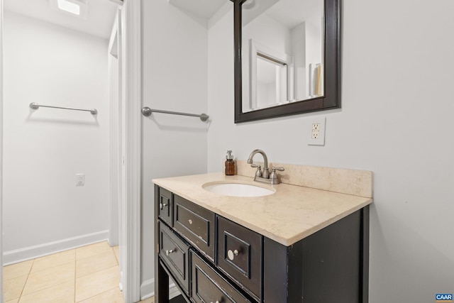 bathroom featuring tile patterned flooring, vanity, and baseboards