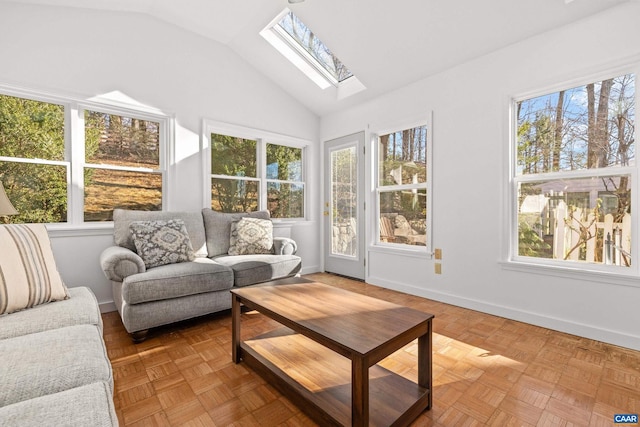 sunroom / solarium featuring lofted ceiling with skylight