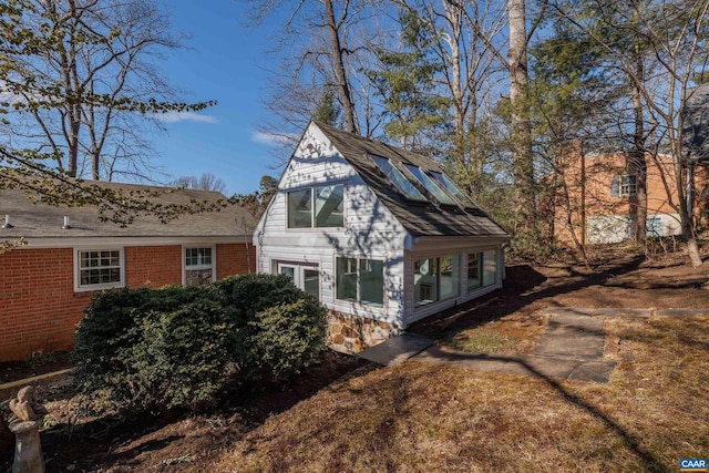 view of side of property featuring brick siding