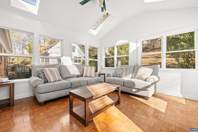 sunroom featuring a ceiling fan and vaulted ceiling with skylight